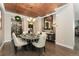 Elegant dining room highlighted by a copper ceiling, stylish chandelier, and convenient wine room access at 19429 W 88Th Dr, Arvada, CO 80007