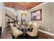 Elegant dining room features a decorative ceiling, chandelier, and sophisticated decor at 19429 W 88Th Dr, Arvada, CO 80007