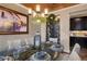 Formal dining room with stylish decor, including a wine fridge and modern chandelier at 19429 W 88Th Dr, Arvada, CO 80007