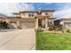 Inviting home exterior boasts a three-car garage, well-manicured lawn, and a charming front garden at 19429 W 88Th Dr, Arvada, CO 80007