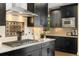 The spacious kitchen includes stainless steel appliances, a gas range, and sleek, dark cabinetry at 19429 W 88Th Dr, Arvada, CO 80007