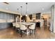 Gourmet kitchen features a large center island with bar seating, dark cabinets, and stainless steel appliances at 19429 W 88Th Dr, Arvada, CO 80007