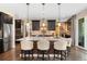 The stunning kitchen island with bar stool seating and pendant lighting is perfect for entertaining at 19429 W 88Th Dr, Arvada, CO 80007