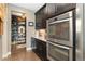 The kitchen boasts stainless steel appliances and dark wood cabinets with a walk-in wine storage area at 19429 W 88Th Dr, Arvada, CO 80007