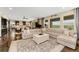 Open-concept living room with large windows offering views of the plains and a neutral colored couch at 19429 W 88Th Dr, Arvada, CO 80007