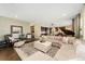 The open-concept living room features a neutral palette, hardwood floors, and abundant natural light at 19429 W 88Th Dr, Arvada, CO 80007