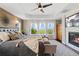 Serene main bedroom boasts a tray ceiling, wood-paneled accent wall, and a cozy fireplace at 19429 W 88Th Dr, Arvada, CO 80007