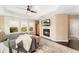The bright main bedroom features a fireplace and outdoor views from the large windows at 19429 W 88Th Dr, Arvada, CO 80007