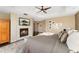 The luxurious main bedroom features a fireplace, a tray ceiling, and soft neutral tones at 19429 W 88Th Dr, Arvada, CO 80007