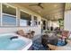 Covered patio with a hot tub and comfortable seating area, great for outdoor living at 19429 W 88Th Dr, Arvada, CO 80007
