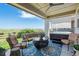 Relaxing outdoor patio features a seating area, hot tub, and scenic views at 19429 W 88Th Dr, Arvada, CO 80007