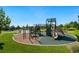 Community playground with swings, slides, and climbing structures on a well-maintained surface at 19429 W 88Th Dr, Arvada, CO 80007