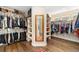 Spacious walk-in closet with custom shelving and hardwood floors, offering ample storage at 19429 W 88Th Dr, Arvada, CO 80007