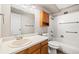 Standard bathroom featuring white tiling, vanity, and shower/tub combo at 3082 S Wheeling Way # 202, Aurora, CO 80014