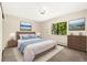 Light-filled primary bedroom with neutral carpet, serene artwork, and a large window with nature views at 3082 S Wheeling Way # 202, Aurora, CO 80014