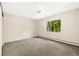 Comfortable bedroom with neutral carpet, ceiling fan, and bright window at 3082 S Wheeling Way # 202, Aurora, CO 80014