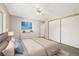 Well-lit bedroom with a ceiling fan, closet, and a beautifully decorated bed at 3082 S Wheeling Way # 202, Aurora, CO 80014