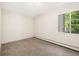 Empty, sunlit bedroom with neutral walls, carpet, and a window at 3082 S Wheeling Way # 202, Aurora, CO 80014