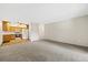 Spacious living area featuring a neutral color palette, carpet and a kitchen space at 3082 S Wheeling Way # 202, Aurora, CO 80014