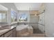 Bright bathroom with a large tub and a glass-enclosed shower and lots of natural light at 9382 Lark Sparrow Dr, Highlands Ranch, CO 80126