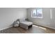 Comfortable bedroom space with a lounge chair and plenty of natural light from a big window at 9382 Lark Sparrow Dr, Highlands Ranch, CO 80126