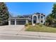 Charming two-story home with a three car garage, landscaped yard, and a modern exterior design at 9382 Lark Sparrow Dr, Highlands Ranch, CO 80126