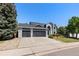 Charming two-story home with a three car garage, landscaped yard, and a modern exterior design at 9382 Lark Sparrow Dr, Highlands Ranch, CO 80126