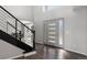Bright foyer with a modern staircase and sleek front door at 9382 Lark Sparrow Dr, Highlands Ranch, CO 80126