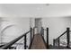 Second story hallway between two staircases with metal railing at 9382 Lark Sparrow Dr, Highlands Ranch, CO 80126