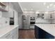 Kitchen featuring stainless steel appliances and an island with a white countertop and blue cabinetry at 9382 Lark Sparrow Dr, Highlands Ranch, CO 80126