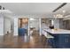 Open concept kitchen and living area with an island and a wet bar at 9382 Lark Sparrow Dr, Highlands Ranch, CO 80126
