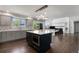 Open kitchen with a spacious island, stainless steel appliances, and modern lighting at 9382 Lark Sparrow Dr, Highlands Ranch, CO 80126
