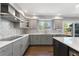 Modern kitchen with stainless steel appliances, gray cabinets, and a window above the sink at 9382 Lark Sparrow Dr, Highlands Ranch, CO 80126