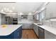 Modern kitchen featuring stainless steel appliances, a blue island, and gray cabinets at 9382 Lark Sparrow Dr, Highlands Ranch, CO 80126