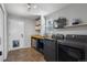 Well-organized laundry room with sink, counter space, shelving and modern washer and dryer units at 9382 Lark Sparrow Dr, Highlands Ranch, CO 80126