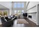 Bright living room boasts fireplace, large windows, vaulted ceilings, and open floor plan at 9382 Lark Sparrow Dr, Highlands Ranch, CO 80126