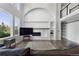 Bright living room boasts fireplace, large windows, vaulted ceilings, and open floor plan at 9382 Lark Sparrow Dr, Highlands Ranch, CO 80126