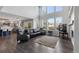 Bright living room boasts fireplace, large windows, vaulted ceilings, and open floor plan at 9382 Lark Sparrow Dr, Highlands Ranch, CO 80126