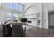 Bright living room boasts fireplace, large windows, vaulted ceilings, and open floor plan at 9382 Lark Sparrow Dr, Highlands Ranch, CO 80126
