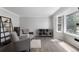 Cozy living room featuring modern decor, wood floors, and ample natural light from a large window at 9382 Lark Sparrow Dr, Highlands Ranch, CO 80126