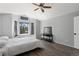 Bright main bedroom featuring a ceiling fan, wood floors, and a sunny window at 9382 Lark Sparrow Dr, Highlands Ranch, CO 80126