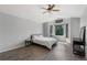 Comfortable bedroom features wood-look floors and plenty of natural light from large windows at 9382 Lark Sparrow Dr, Highlands Ranch, CO 80126