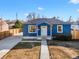 Charming blue home boasts a welcoming entryway and a spacious driveway at 2826 W Park Pl, Denver, CO 80219