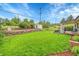 Spacious backyard features a well-maintained lawn, shed, patio and stone retaining wall at 3450 W Amherst Ave, Denver, CO 80236
