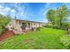 Expansive backyard boasts lush green grass, a charming patio area, and mature trees, creating a serene outdoor retreat at 3450 W Amherst Ave, Denver, CO 80236