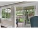 View of the private backyard with sliding glass doors, lovely landscaping, and a patio with outdoor seating at 3450 W Amherst Ave, Denver, CO 80236
