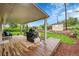 Backyard featuring a covered patio, a grill, lush landscaping, and a storage shed at 3450 W Amherst Ave, Denver, CO 80236