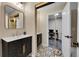 Stylish bathroom with a unique vanity, decorative mirror, and views of the office at 3450 W Amherst Ave, Denver, CO 80236
