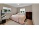 Cozy bedroom featuring neutral tones, natural light, and a comfortable quilt-covered bed at 3450 W Amherst Ave, Denver, CO 80236