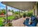 Inviting covered patio features stylish outdoor furniture and a grill, perfect for relaxing and entertaining in the landscaped backyard at 3450 W Amherst Ave, Denver, CO 80236